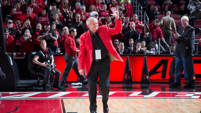 Louisville Cardinals coach Denny Crum waves at crowd 