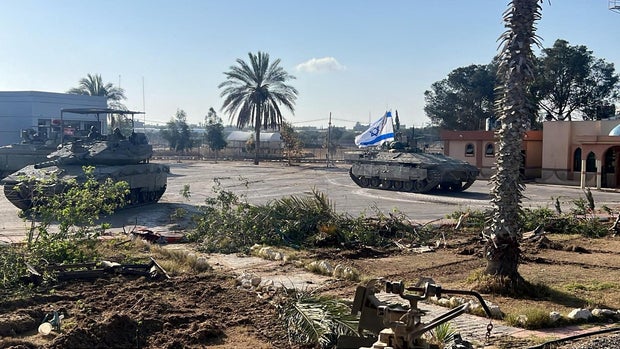 Israeli military vehicles operate on the Gaza side of the Rafah border crossing with Egypt, amid the ongoing conflict between Israel and the Palestinian militant group Hamas, in the southern Gaza Strip, in a handout image released May 7, 2024, by the Israel Defense Forces. 