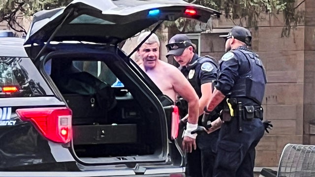 Law enforcement officers detain a suspect  after an attack that injured multiple people, in Boulder 